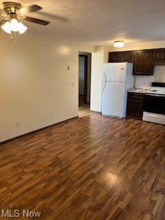 Kitchen featuring white appliances, dark brown cab