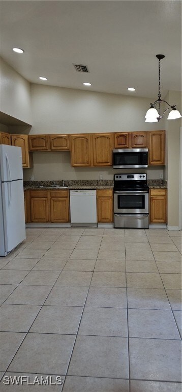 Kitchen with range, refrigerator, white dishwasher