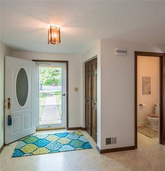 A bright powder room is to the right of the entry.