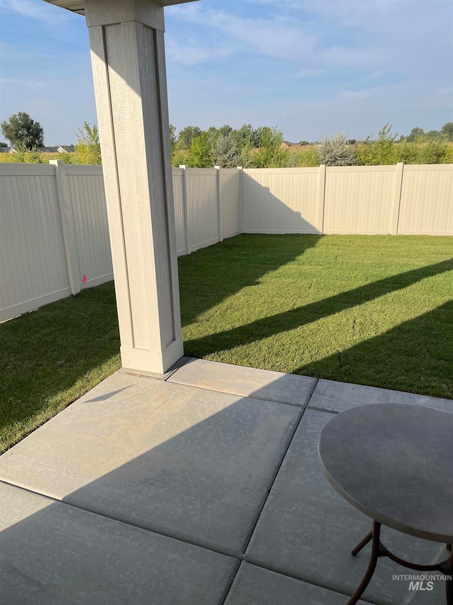 Fenced backyard featuring a patio