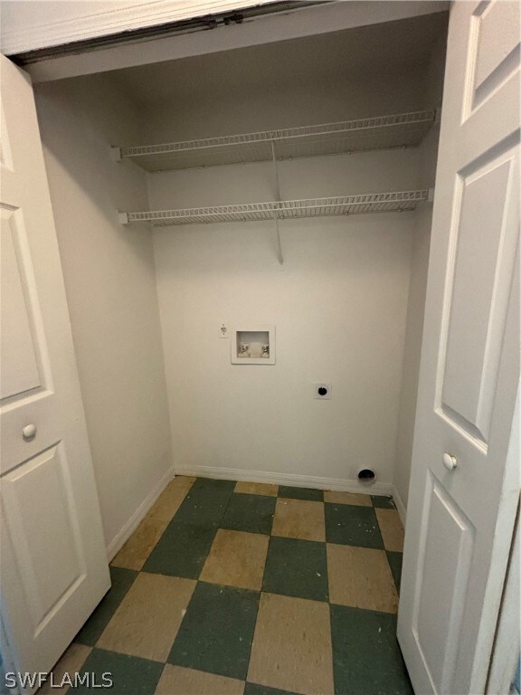 Laundry room with tile floors, hookup for a washing machine, and hookup for an electric dryer