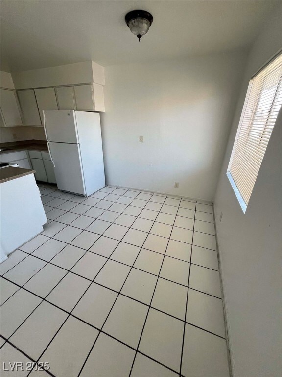 Unfurnished dining area with light tile patterned