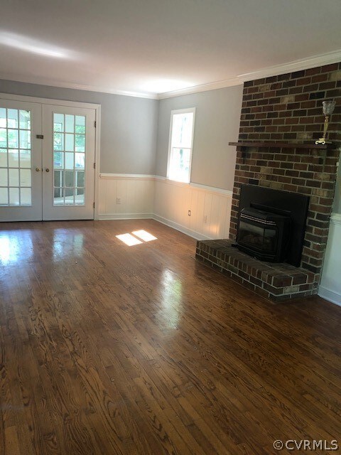 Gorgeous hardwood floors and a brick fireplace kee