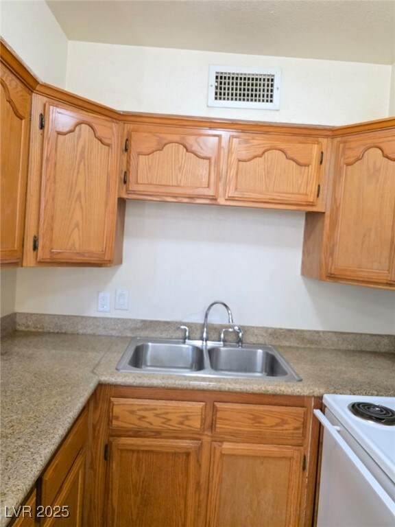 Kitchen featuring a sink and light countertops