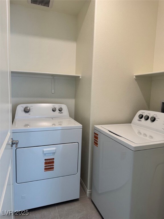 Laundry room featuring visible vents, washing mach