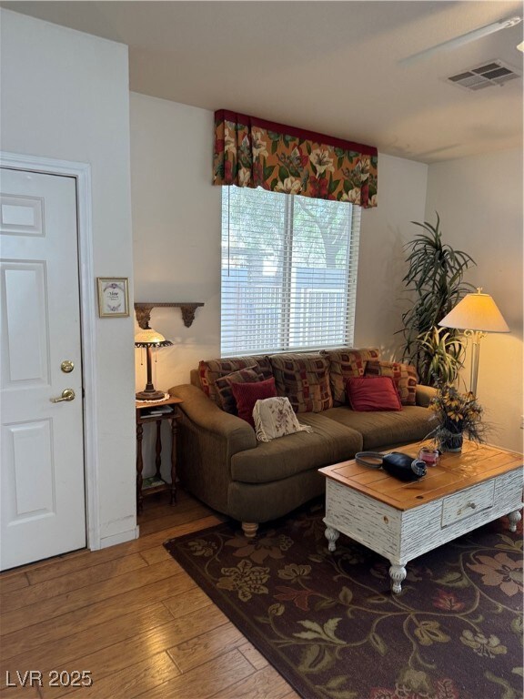 Living room with visible vents and light wood-styl