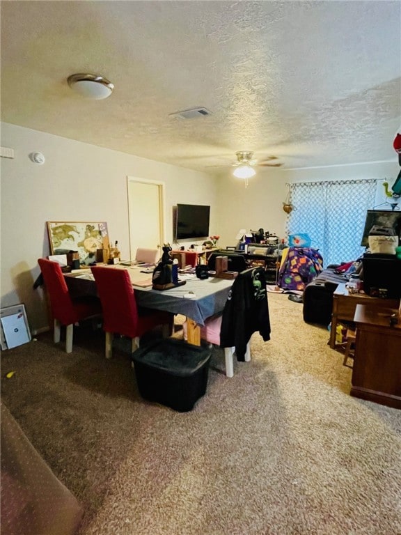 Carpeted dining room with visible vents, a texture