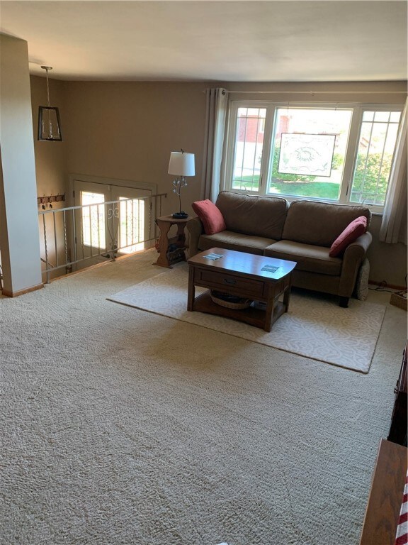 Spacious living room with neutral carpet.