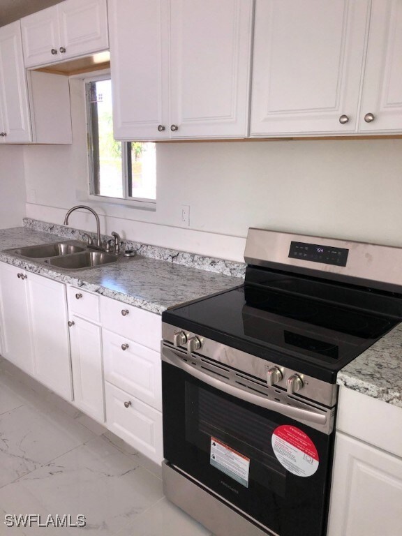 Kitchen with stainless steel electric stove, light