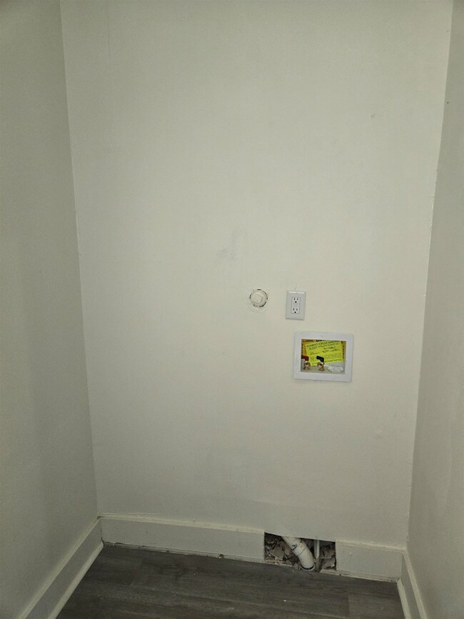Laundry area featuring baseboards, hookup for a washing machine, and dark wood-type flooring