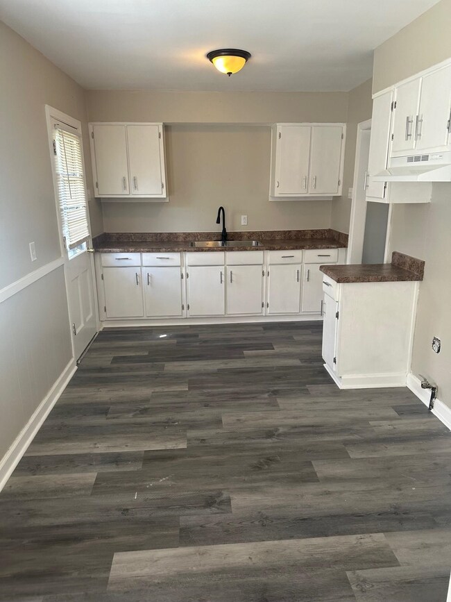 Kitchen with under cabinet range hood, dark wood-s