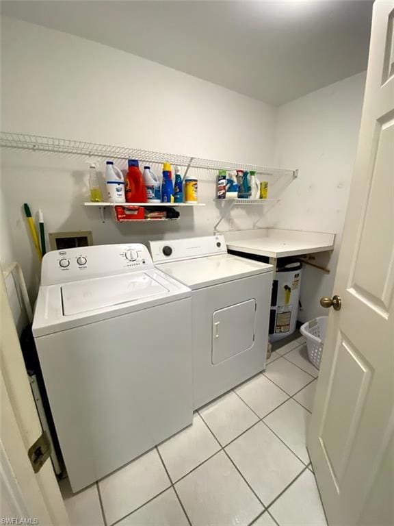 Clothes washing area featuring light tile patterne