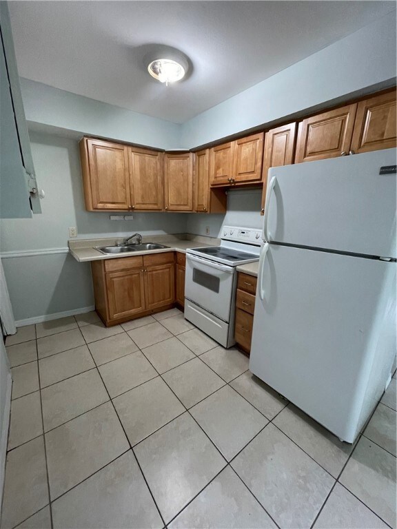 Kitchen with range and refrigerator