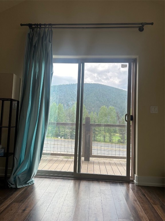 Doorway featuring a mountain view and hardwood / w