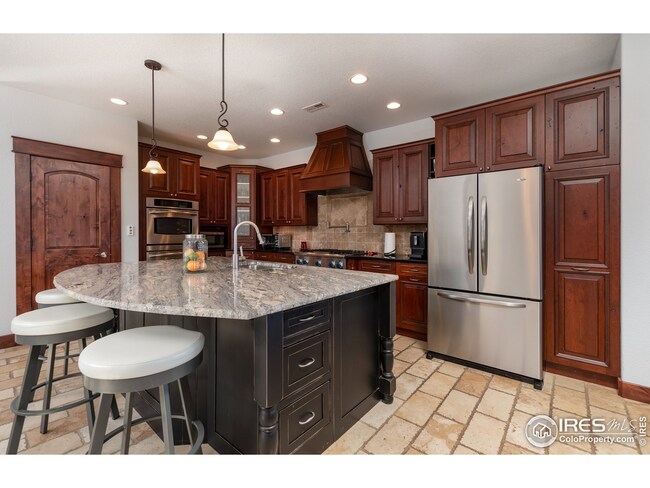 Beautiful cabinetry, granite counters, stainless appliances, double ovens & large island