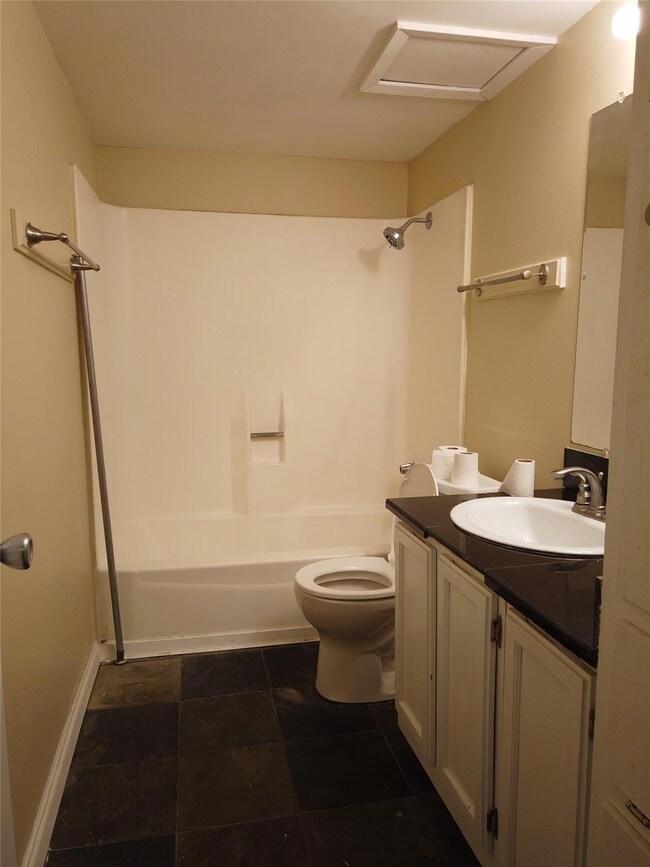 Bathroom with vanity, shower / tub combination, a