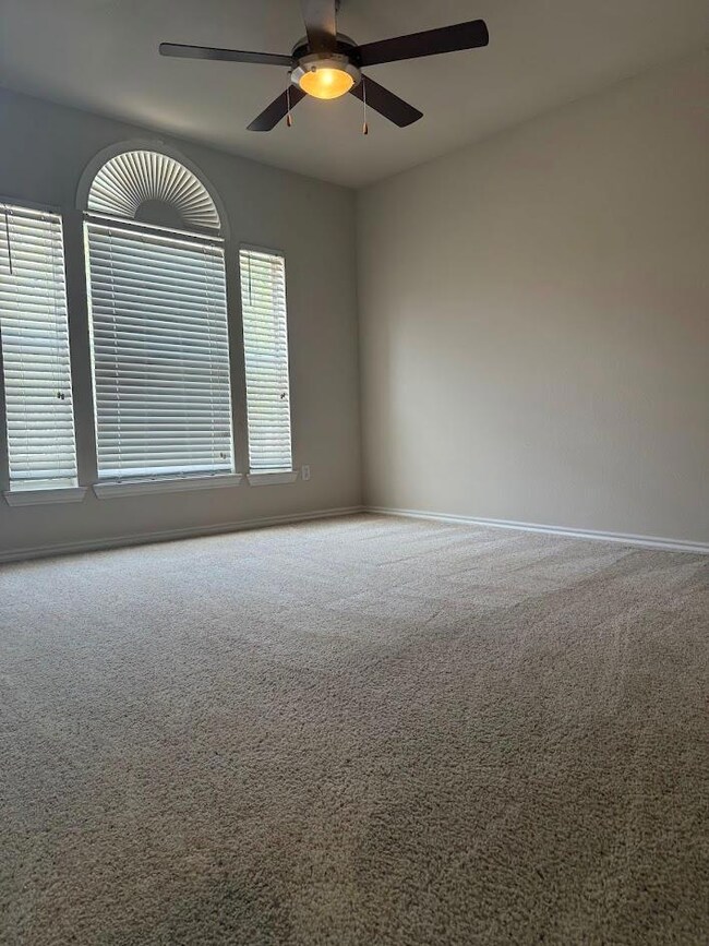 Unfurnished room featuring carpet floors and a ce