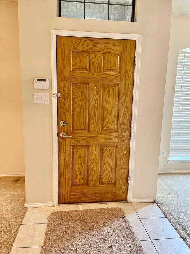View of carpeted entrance foyer