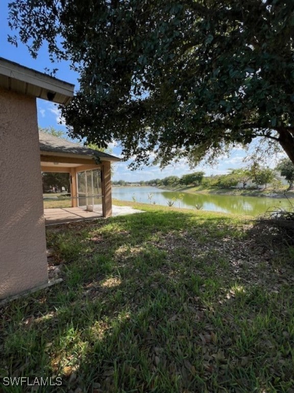 View of yard with a water view