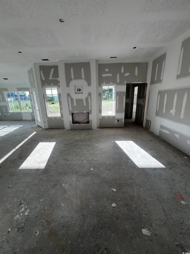 Unfurnished living room featuring a textured ceiling
