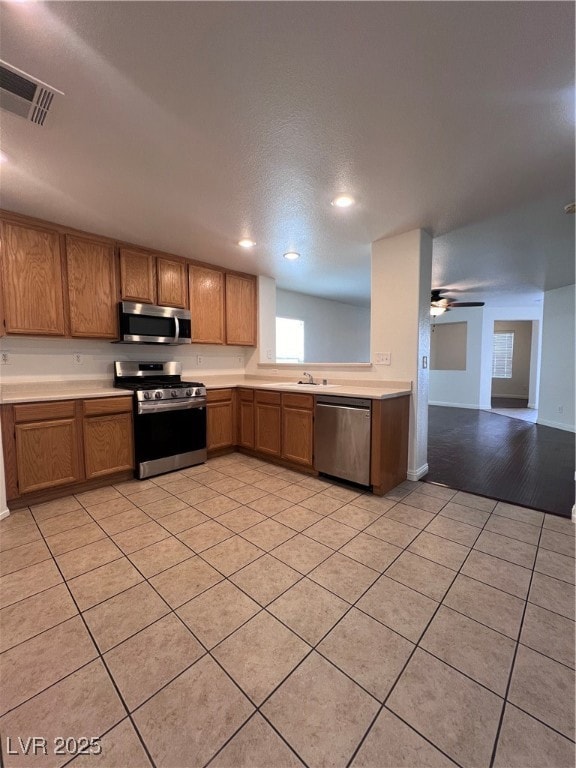 Kitchen with stove, dishwasher, light countertops,