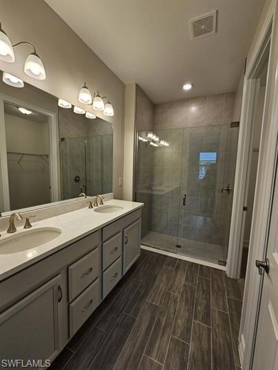 Bathroom featuring a shower stall, wood tiled floo