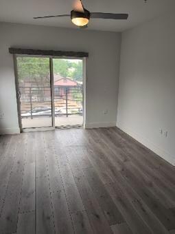 Spare room featuring wood finished floors and bas