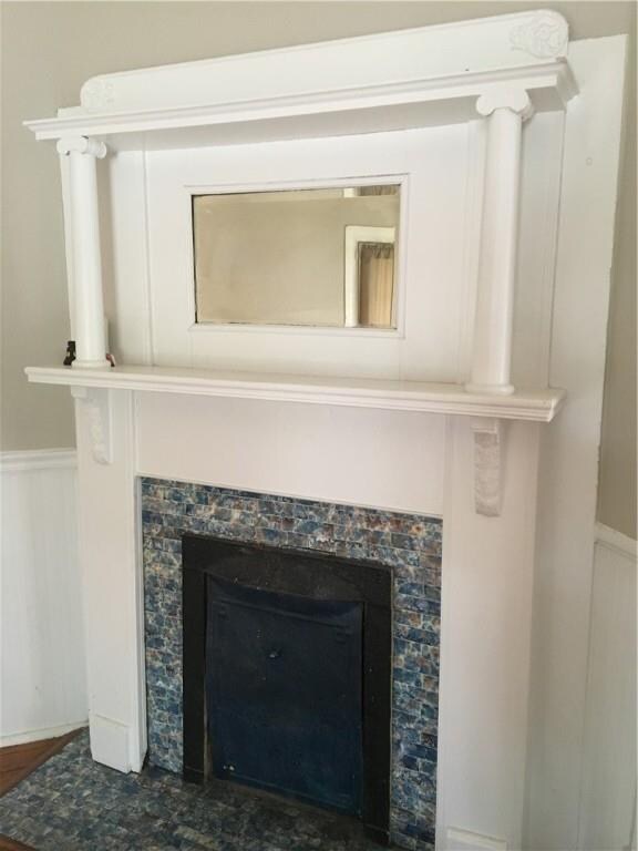 Original decorative fireplace in front living area
