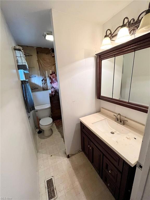 Bathroom featuring vanity with extensive cabinet s