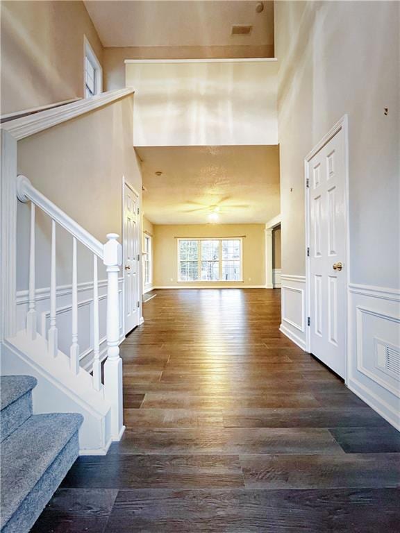 Entrance foyer with a wainscoted wall, a towering 