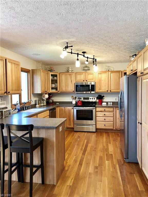 Oak hardwood flooring, Hickory cabinets, corian co