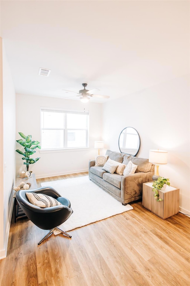 Living room featuring wood finished floors and ceiling fan