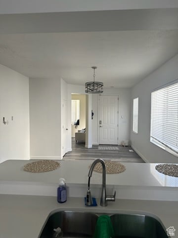 Kitchen featuring a chandelier, hanging light fixtures, and wood finished floors