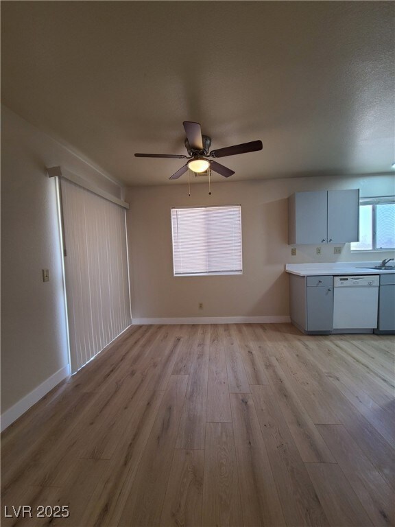 Unfurnished living room featuring ceiling fan and