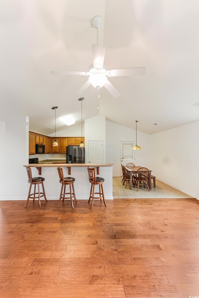 Kitchen with stainless steel fridge, light hardwoo