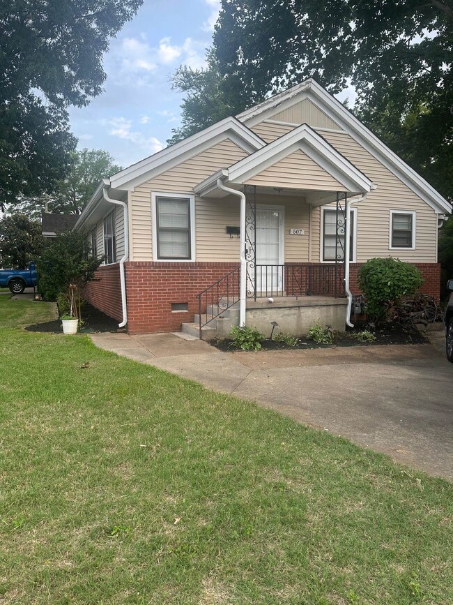 View of front of house with brick siding, a front 