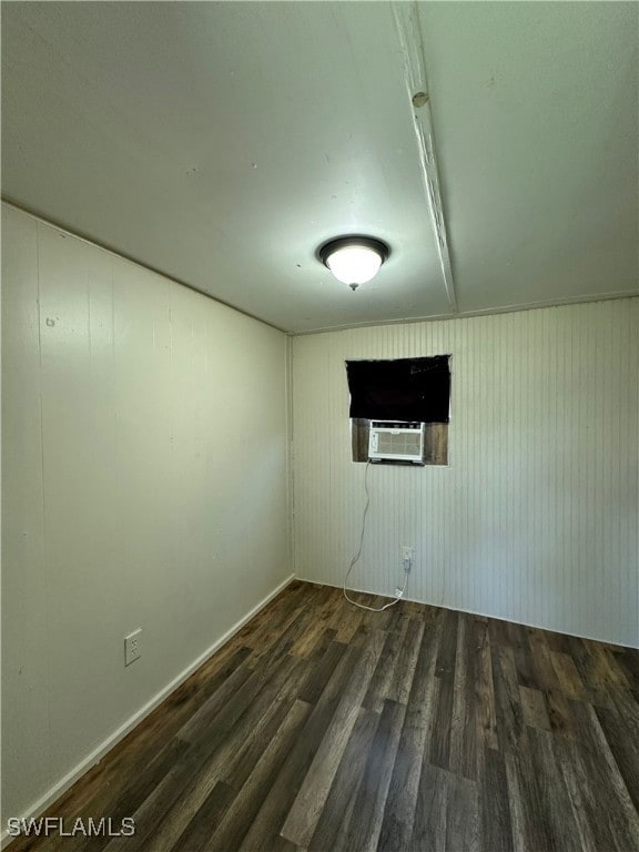 Unfurnished room with wood finished floors and coo