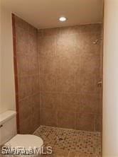 Full bathroom featuring toilet, recessed lighting,
