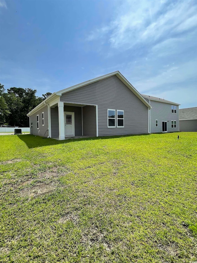 Back of property with a yard