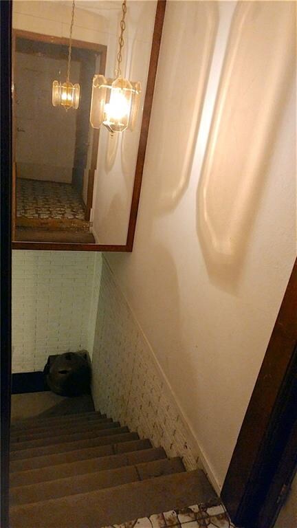 Entry way with open stairs to basement.