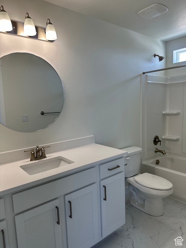 Full bathroom with vanity, shower / bath combination, and light marble finish floors