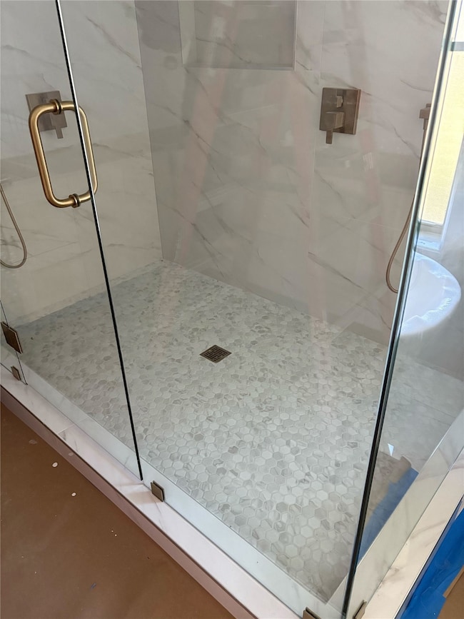 Bathroom with a marble finish shower