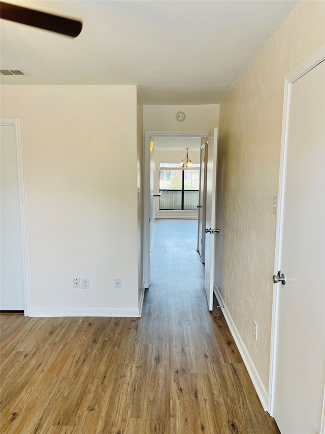Hallway with wood finished floors