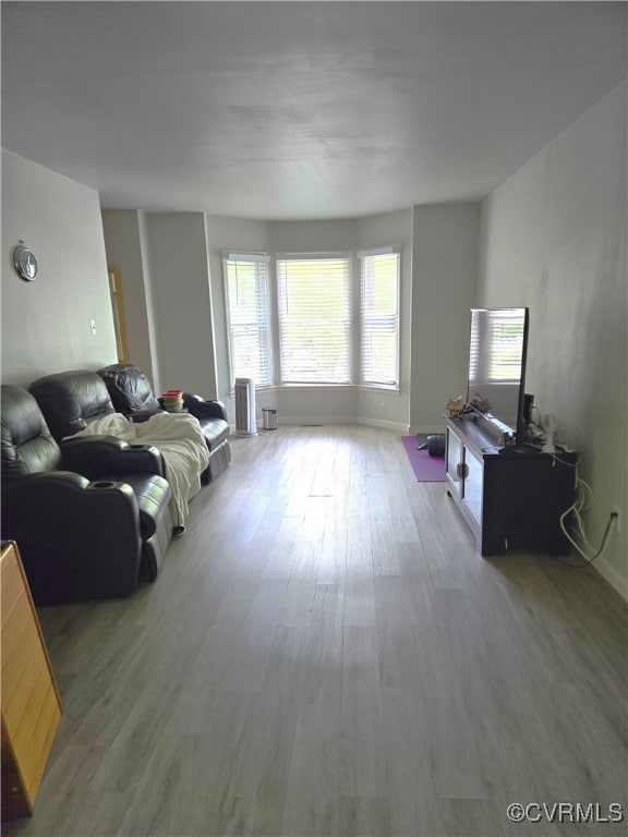 Living room with baseboards and wood finished floo