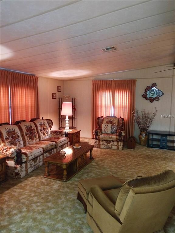 Living room features vaulted ceiling and ceiling f