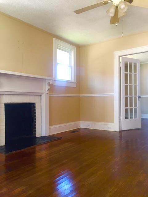 Living Room fireplace with french doors and beautiful real hardwood floors