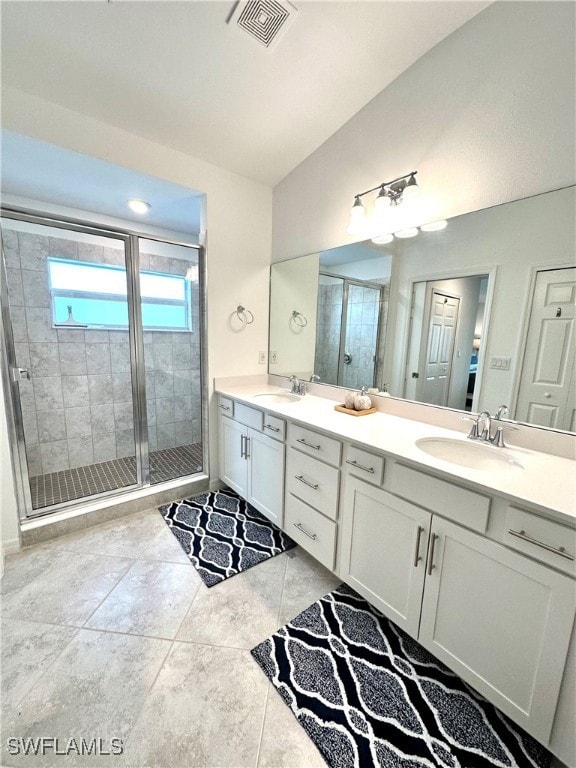 Bathroom with tile floors, dual sinks, a shower wi
