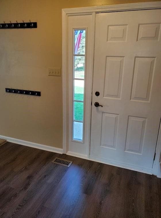 Welcoming Entry with Vinyl Plank flooring and Coat Closet