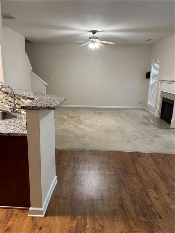 Unfurnished living room featuring wood finished fl