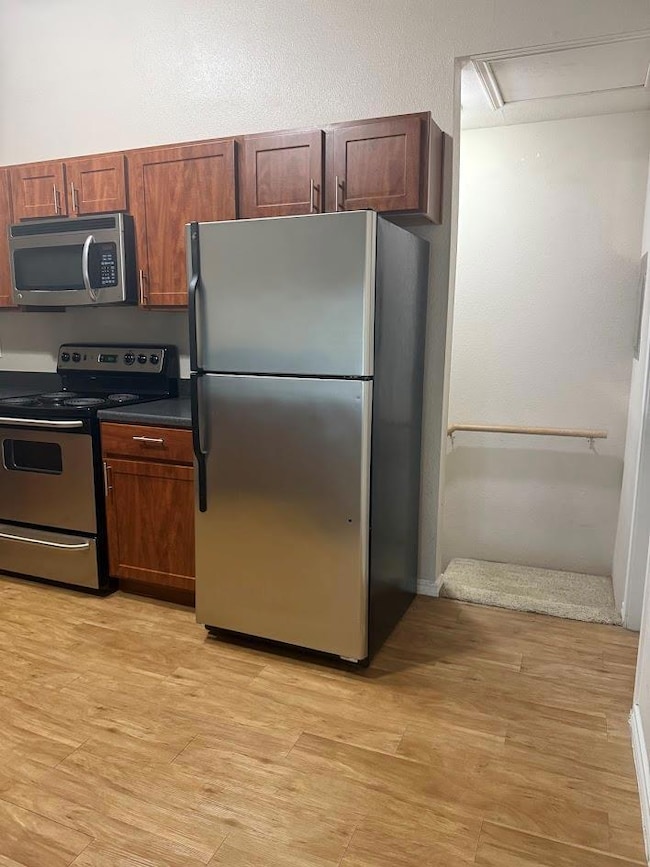 Kitchen featuring stainless steel appliances and dark countertops